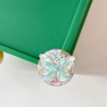 Detail of phone grip featuring a holographic butterfly, blue ribbon bow and colorful sequins - Blue Butterfly