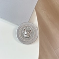 Macro detail of silver magnetic phone grip featuring a Labubu bear and sparkling rhinestones - Rhinestone Pearl Bearbrick Head / Silver