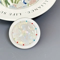 Macro shot of phone socket with pearl shell texture, star design and colorful rhinestones - Aurora Star