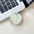 Close-up of light green heart-shaped phone grip with matte finish on a white desk - Matte Shimmer Light Green