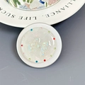 Close-up of a pearl white bow magnetic phone grip with colorful rhinestones on a grey base - Aurora Multi-layer Bowtie