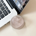 Detail of a matte peach 3D heart phone socket grip on a silver laptop surface - Matte Shimmer Brown