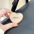 Close-up of glittery heart-shaped magnetic phone grip with Luckyhorse metallic logo detail - Stereo Heart - Pink Glitter / Adhesive Stand Style
