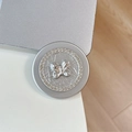Close-up of silver magnetic Magsafe phone grip with embossed butterfly and crystal border - Rhinestone Pearl Fat Butterfly / Silver