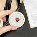 Macro shot of magnetic telescopic phone grip with red heart gemstone and rhinestones - Matte Silver Magnetic - Sweetheart / Burgundy