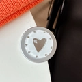 Detail of a round magnetic phone grip with an integrated heart-shaped mirror and silver frame - Matte Silver Magnetic - Dopamine Small Heart Mirror / White