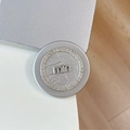 Close-up of silver magnetic MagSafe phone stand with rhinestones and miu logo detail - Rhinestone Pearl Small Mini / Silver