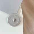 Close-up of magnetic phone grip with silver star design and crystal-encrusted outer rim - Rhinestone Pearl Chubby Star / Silver