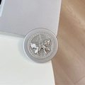Close-up of silver magnetic MagSafe phone grip with luxury rhinestone bow decoration - Rhinestone Pearl Swallowtail Bowtie / Silver