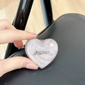 Macro shot of glittery purple heart phone grip featuring a Luckyhorse relief logo - Stereo Heart - Brown Glitter / Adhesive Stand Style