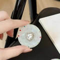 Close-up of a magnetic heart-shaped rhinestone phone grip with pearl finish for women - Transparent Stand - Sweetheart / White