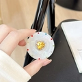 Macro shot of magnetic grip tok with heart yellow gem and multicolored crystal rhinestones - Transparent Stand - Sweetheart / Yellow