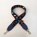 Macro detail of adjustable planet print shoulder strap with gold metal lobster clasps - Blue