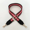 Detail of adjustable wide shoulder strap with red, white, and black stripes and gold hardware - Red Striped + Black Leather