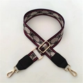 Detail of adjustable wide bag strap with striped edges and golden metal lobster clasps - Red Gold Pattern + Black Leather