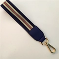 Detail of woven wrist strap with iconic red and green stripes and gold lobster clasp - Blue
