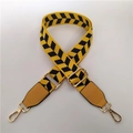 Close-up of adjustable yellow geometric pattern shoulder strap with gold metal hooks - Bright Yellow Black Plaid + Yellow Leather