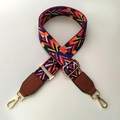 Detail of adjustable geometric patterned woven bag strap with golden metal hooks - Rainbow Style with Brown Leather