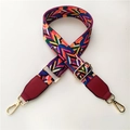 Close-up of bohemian wide bag strap with colorful geometric patterns and gold metal hooks - Rainbow Style with Wine Red Leather