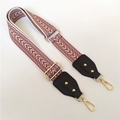 Close-up of ethnic style woven strap with geometric patterns and golden metal buckles - Light Blue + Black Leather Trim