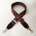Detail of adjustable geometric strap with gold hooks and black leather accents - Brown Style with Black Leather