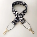 Close-up of black and white geometric ethnic strap with gold metal lobster clasps - Black & White with White Leather