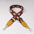 Close-up of ethnic style woven bag strap with geometric patterns and golden metal hooks - No.1 + Yellow Leather Trim