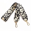 Detail of wide leopard print handbag strap with thick fabric and gold metal hooks - Khaki
