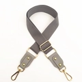 Detail of gray cotton woven adjustable shoulder strap with gold metal lobster clasps - Gray