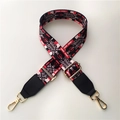Close-up of adjustable wide woven shoulder strap with red hearts and gold metal hooks - Chic Color with Black Leather
