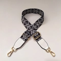 Detail of black and white geometric pattern bag strap with gold metal lobster clasps - No.4 + White Leather Trim