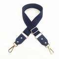 Close-up of wide navy cotton strap with gold hardware and adjustable buckle for bags - Blue