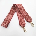 Detail of red and cream geometric woven shoulder strap with gold metal lobster clasps - Red