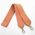 Detail of orange and beige geometric embroidered cotton strap with gold swivel hooks - Orange