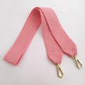 Close-up of pink and khaki geometric woven bag strap with golden metal lobster clasps - Pink