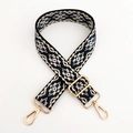 Close-up of geometric jacquard bag strap with adjustable light gold metal hardware - Beige Dark Blue Floral / Silver Clasp