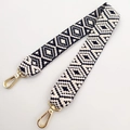 Close-up of black and white geometric diamond weave pattern bag strap with gold lobster clasps - Short Style / Navy Blue