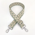 Close-up of thick adjustable crossbody strap with green geometric jacquard and silver hooks - Light Green with Silver Buckle