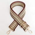 Macro view of geometric wave pattern woven strap with gold metal hooks and buckle - Silver Clasp / Khaki 2