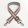 Detail of adjustable woven bag strap with colorful stripes and gray metal swivel hooks - Pink White Stripe Gunmetal Buckle
