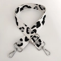 Detailed view of silver lobster clasps and leopard pattern on adjustable bag strap - White Silver Thread + Silver Buckle