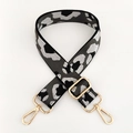 Detail of adjustable leopard print bag strap with polished gold-tone metal lobster clasps - Grey Silver Thread + Gold Buckle