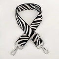 Detail of zebra pattern nylon strap with adjustable silver metal buckle and swivel hooks - White Silver Buckle