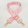 Detail of adjustable pink zebra pattern wide shoulder strap with gold metal lobster hooks - Pink with Gold Buckle
