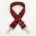 Detail of red and black zebra pattern nylon strap with silver metal swivel hooks - Red With Silver Buckle