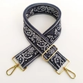Close-up of paisley pattern wide woven shoulder strap with gold metal lobster clasps - Grey