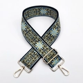 Close-up of ethnic embroidered bag strap with blue floral pattern and gold metal hardware - Light Blue
