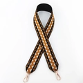 Close-up of geometric pattern wide strap with polished golden lobster clasps - Black with Yellow Floral