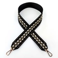 Close-up of ethnic style wavy patterned wide shoulder strap with golden metal lobster clasps - Black Green