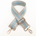 Detail of wide adjustable shoulder strap with blue geometric pattern and gold buckles - Light Blue